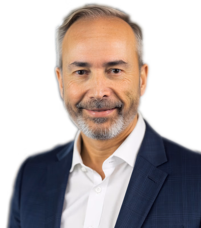 Professional headshot of Jack Behar, cofounder of DealerCX, smiling in a navy suit jacket and white button-down on a transparent background.